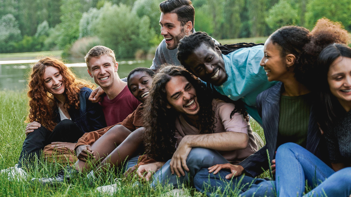 smiling group of people sitting outdoors